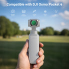 A hand holding a DJI Osmo Pocket 4 equipped with a NEEWER Filter