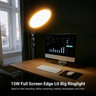 A warm-toned ring light illuminates a home office desk setup, casting soft light on the iMac-style computer while reducing eye strain during work hours.